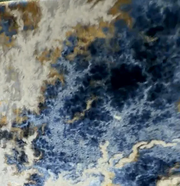 Abstract rug in midnight blue swirled with ivory and gold, like marble.